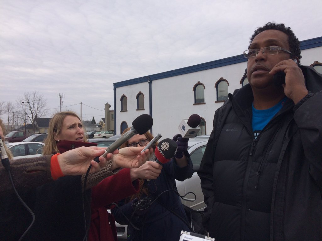Keith Charles talks on a cell phone across the street from the courthouse on Dundas St.