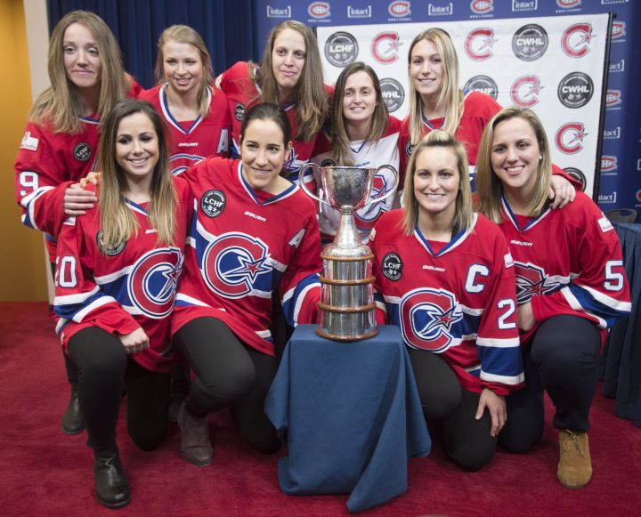 Members of Les Canadiennes de Montreal pose for photos with the Clarkson Cup during a news conference, Wednesday, March 8, 2017 in Brossard, Que.