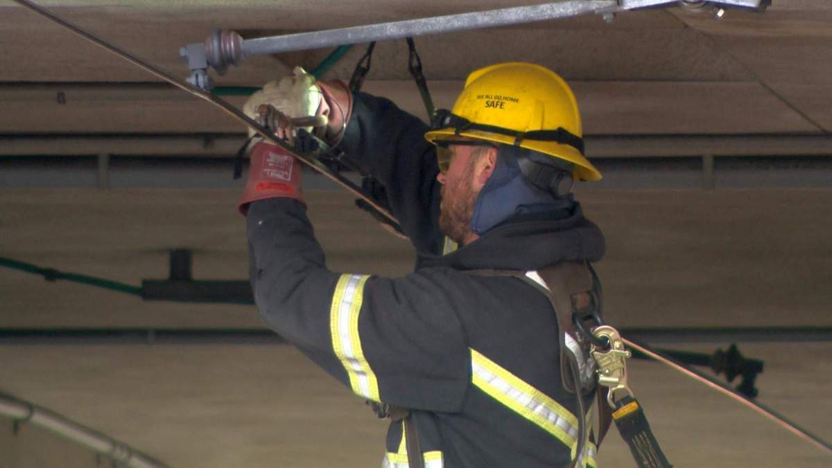 Crews work to fix an electrical issue at the Southland LRT Station on Wednesday, March 22, 2017.