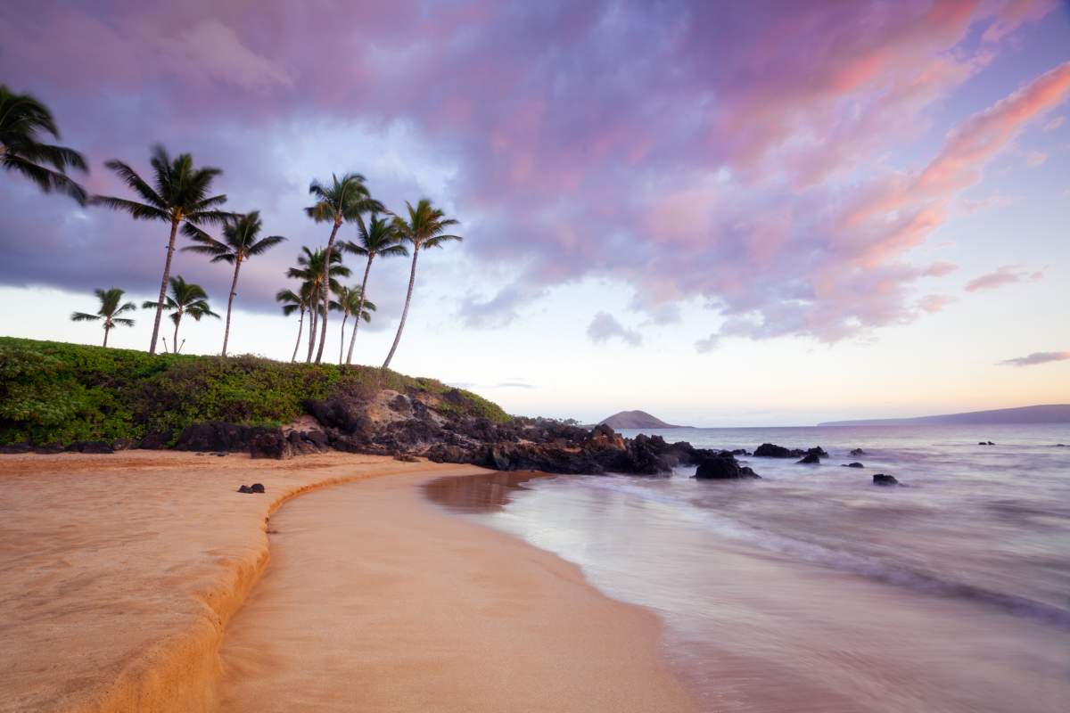 A sunset sets over a south Maui beach in Hawaii.