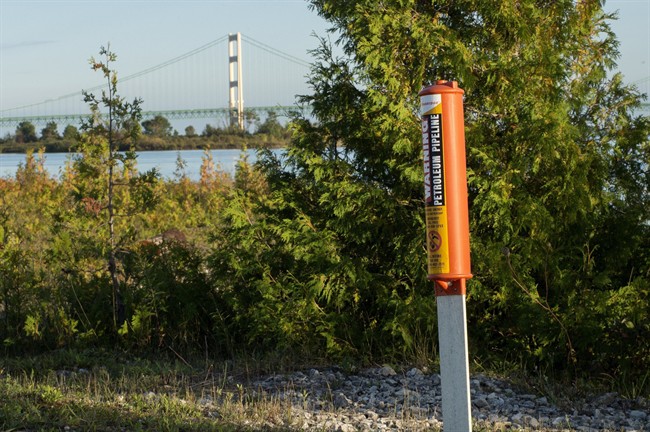 In this Sept. 23, 2015, file photo, the Mackinac Bridge is visible from a marker near Enbridge Line 5 on the northern shore of the Straits of Mackinac in Michigan.
