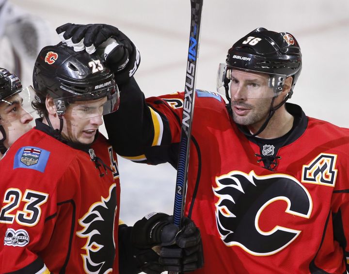Calgary Flames' Sean Monahan, left, celebrates his goal with Troy Brouwer against the Colorado Avalanche during first period NHL action in Calgary, Alta., Monday, March 27, 2017. 