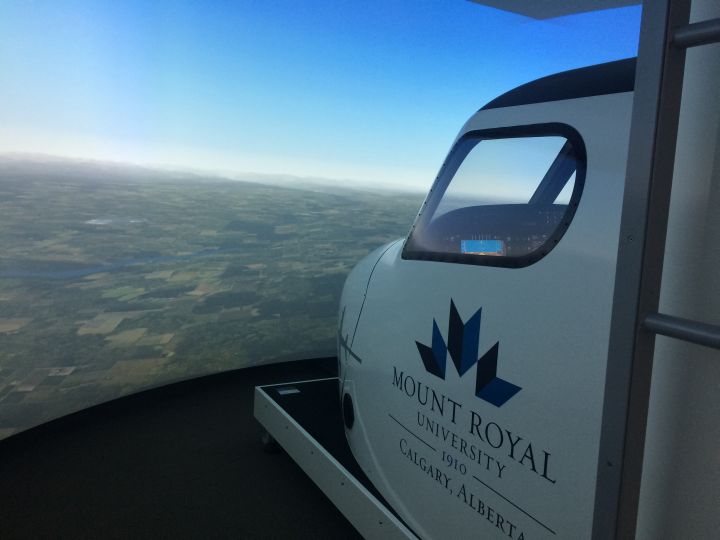People attending the aviation career expo at Mount Royal University Saturday, March 11, 2017 use a flight simulator.