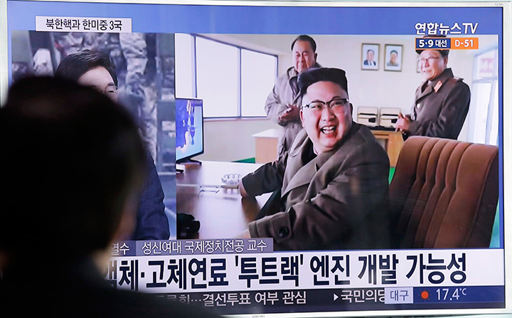 A man watches a TV news program showing an image of North Korean leader Kim Jong Un at the country's Sohae launch site, Sunday, March 19, 2017. 