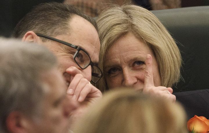 Alberta Finance Minister Joe Ceci and Alberta Premier Rachel Notley, speak to each other during the speech from the throne, in Edmonton on Thursday, March 2, 2017. 