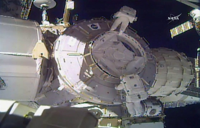 In this image made from video provided by NASA, U.S. astronauts Peggy Whitson, above, and Shane Kimbrough work on the outside of the International Space Station on Thursday, March 30, 2017.