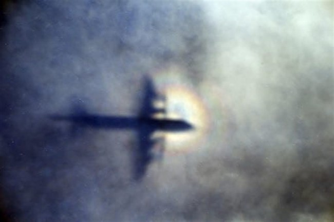 In this March 31, 2014 file photo, the shadow of a Royal New Zealand Air Force P3 Orion is seen on low level cloud while the aircraft searches for missing Malaysia Airlines Flight MH370 in the southern Indian Ocean, near the coast of Western Australia.