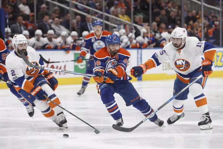 New York Islanders' Nick Leddy (2) and Cal Clutterbuck (15) chase Edmonton Oilers' Jordan Eberle (14) during second period NHL action in Edmonton, Alta., on Tuesday, March 7, 2017. 