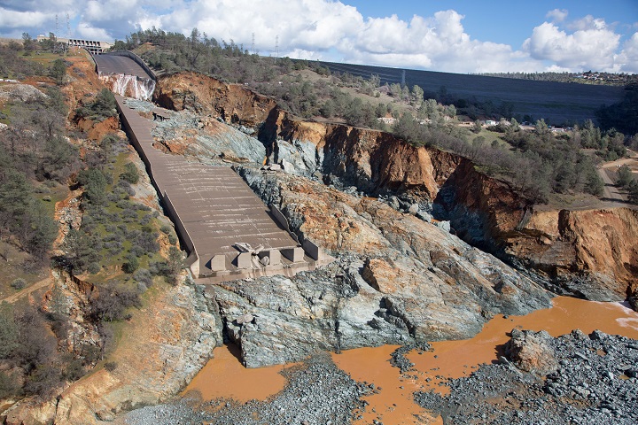 An aerial view of the damaged Oroville Dam spillway site with a huge debris field in the diversion pool area just below the spillway is shown in Oroville, California, U.S. in this February 27, 2017 handout photo. (Dale Kolke / California Department of Water Resources/Handout via REUTERS)