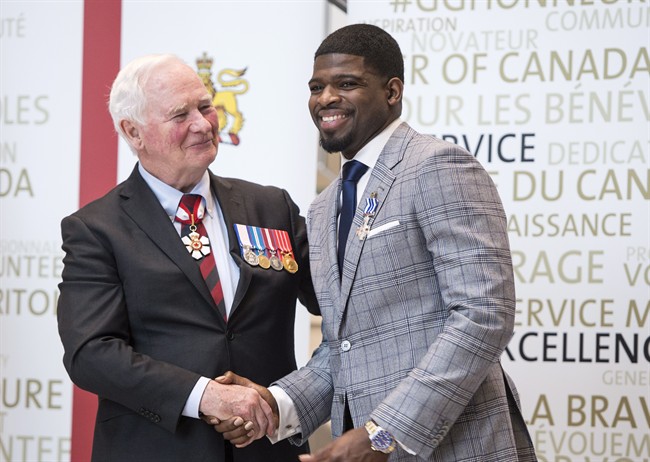 Nashville Predators' P.K. Subban shakes hands with Governor General David Johnston after receiving the Meritorious Service Decoration, Wednesday, March 1, 2017 in Montreal.