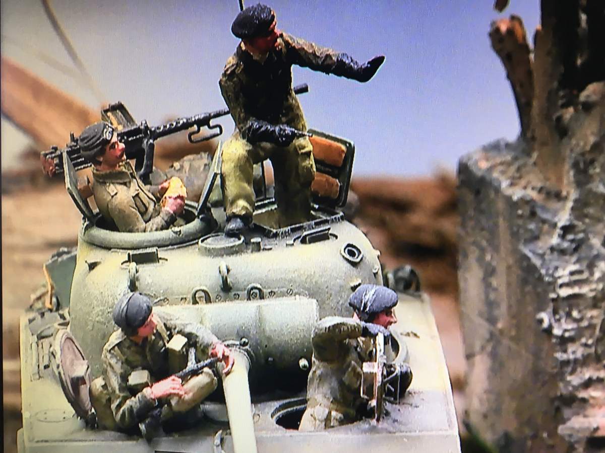 Four replica soldiers sit in a tank in a diorama designed by New Brunswick modeller Nick Dunning.