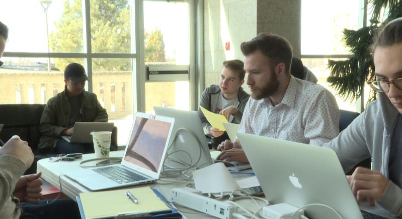 Computer coders building an app from scratch in eight hours, for Queen City Hack competition.