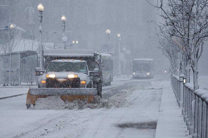 Plows clear snow off the roads in Providence, Rhode Island in this February 9, 2017 file photo.  