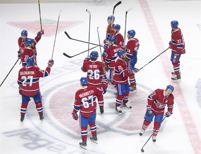 Montreal Canadiens players salute the crowd after defeating the Florida Panthers 6-2 to clinch a playoff spot following NHL hockey action in Montreal on Thursday, March 30, 2017.