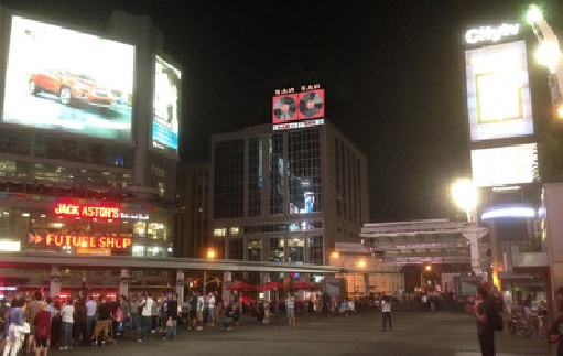 Composite image of the Sam The Record Man sign atop 277 Victoria Street in downtown Toronto.