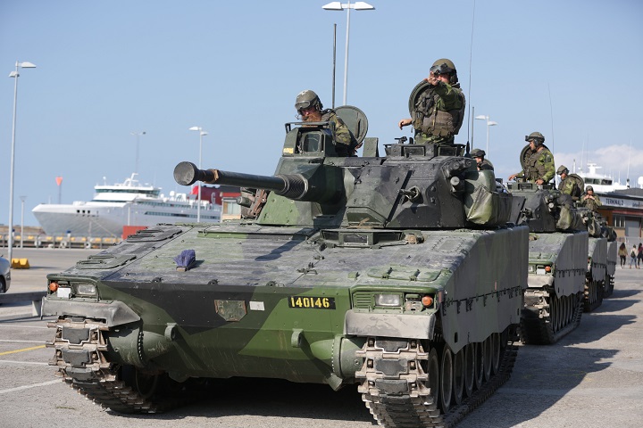 FILE - In this Sep. 14, 2016 file photo, Swedish APCs are seen in Visby harbour on the island of Gotland, Sweden. Sweden's left-leaning government on Thursday, March 2, 2017 reintroduced a military draft for both men and women because of what Defense Minister Peter Hultqvist calls a deteriorating security environment in Europe and around Sweden.