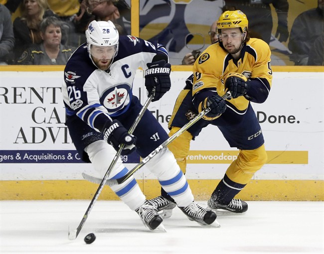 Winnipeg Jets right wing Blake Wheeler (26) and Nashville Predators left wing Filip Forsberg (9), of Sweden, battle for the puck during the second period of an NHL hockey game Monday, March 13, 2017, in Nashville, Tenn. 