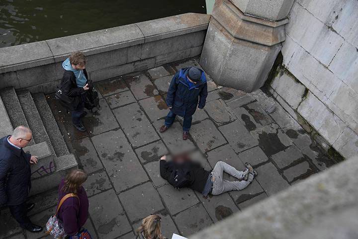 A man lies injured after an incident on Westminster Bridge in London, March 22, 2017.