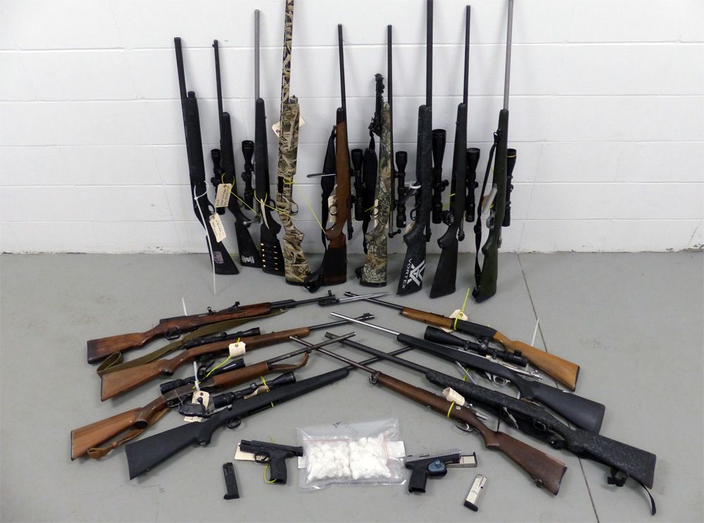 ALERT display of the twenty-two guns and drugs seized from property in the Whitecourt area. 