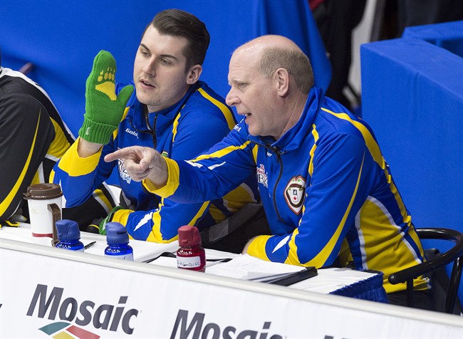 Canadian curling great Kevin Martin, coach of the Alberta team, talks with alternate Evan Asmussen during draw 6 action against New Brunswick at the Tim Hortons Brier curling championship at Mile One Centre in St. John's on Monday, March 6, 2017. 