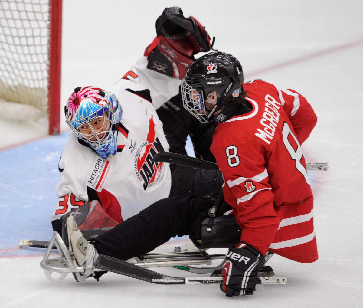 Canada's Tyler McGregor, right, has a second period shot stopped by Japan's goalie Mitsuru Nagase during semi-final World Sledge Hockey Challenge action in Calgary, Alberta on Thursday, Dec. 6, 2012. THE CANADIAN PRESS/Larry MacDougal.