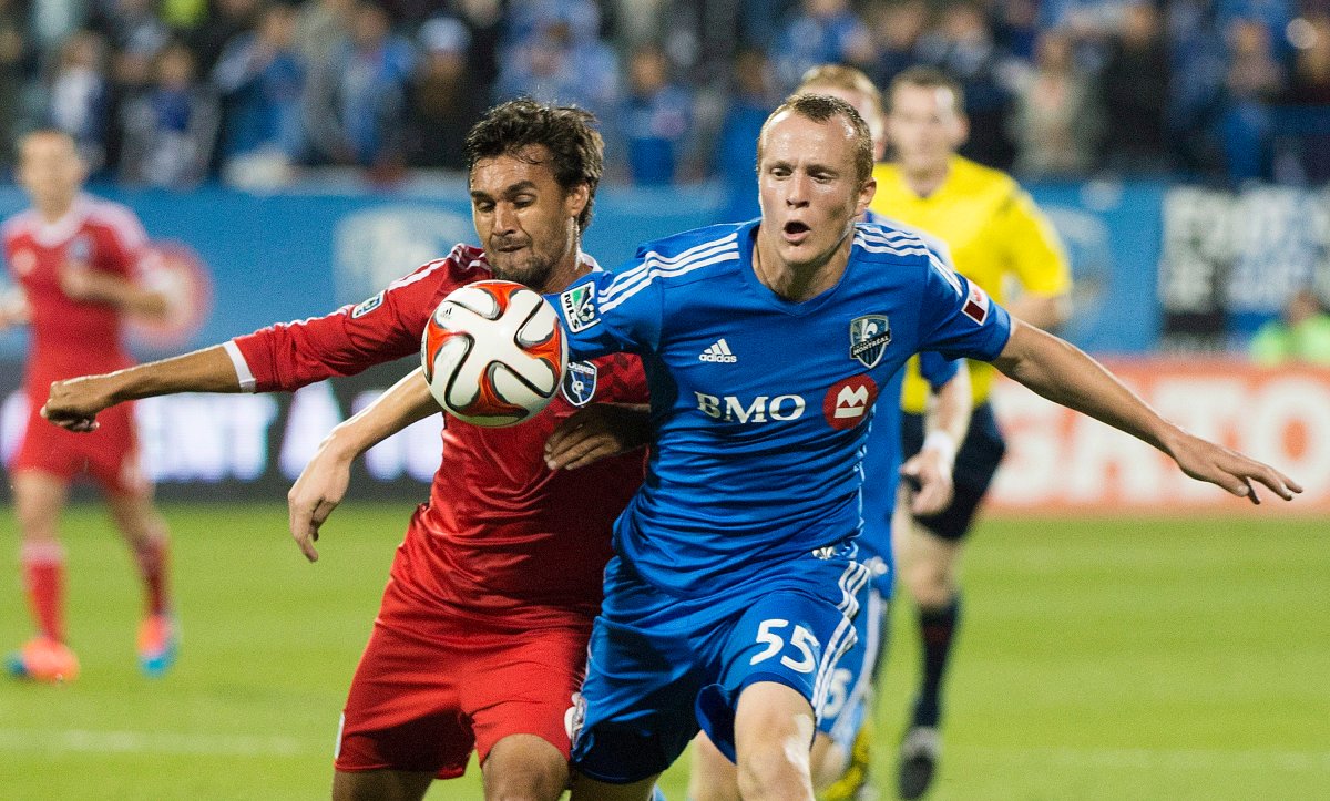 Montreal Impact's Wandrille Lefevre, right, and San Jose Earthquakes' Chris Wondolowski battle for the ball during first half MLS soccer action in Montreal, Saturday, September 20, 2014. The Montreal Impact suspended Lefevre on Wednesday, a day after the defender posted a picture of himself holding a gun with a caption referencing U.S President Donald Trump on social media.