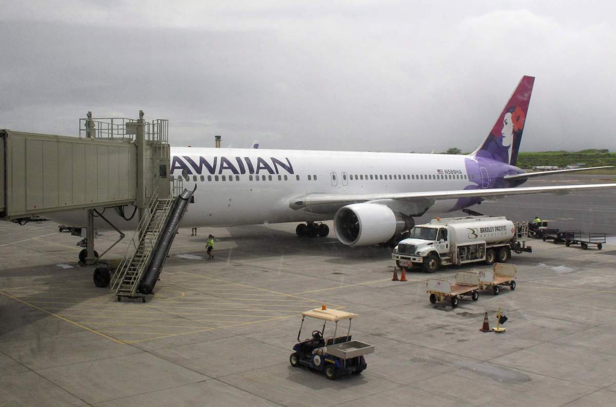 In this April 21, 2014 file photo, a Hawaiian Airlines flight arrives from San Jose, Calif., in Kahului Airport in Kahului, Hawaii.
