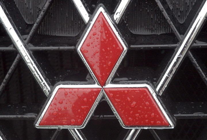 A close-up of the Mitsubishi logo in red.
