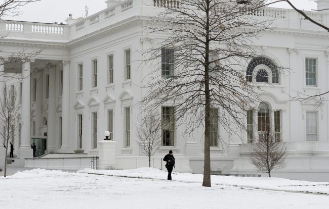 A uniform secret service patrols on the North Portico of the White House in Washington, DC, March 15, 2017.