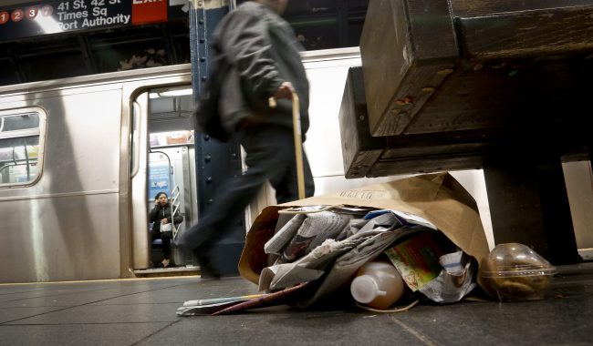 Garbage collects near a set of benches on a subway platform, Thursday March 30, 2017, in New York. 