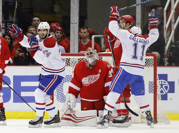 Montreal Canadiens' Phillip Danault (24) and Brendan Gallagher (11) celebrate a Nathan Beaulieu goal against Detroit Red Wings goalie Petr Mrazek (34) in the second period of an NHL hockey game Saturday, April 8, 2017, in Detroit. 