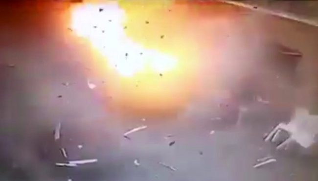 A man sitting at right is engulfed by the blast as a suicide bomber detonates at the front gates into St. Mark’s Coptic Cathedral in Alexandria, Egypt, Sunday April 9, 2017.