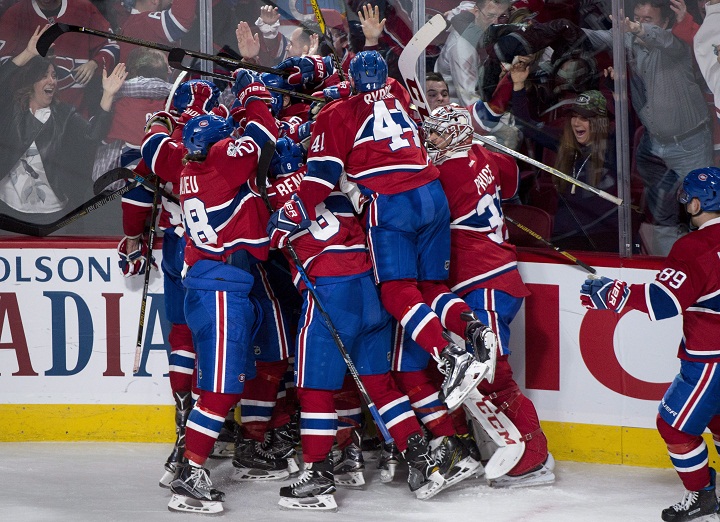 Members of the Montreal Canadiens pile onto Alexander Radulov after scoring the winning goal against the New York Rangers during overtime Game 2 NHL Stanley Cup first round playoff hockey action Friday, April 14, 2017 in Montreal. The Canadiens beat the Rangers 4-3 to tie the series at 1-1.