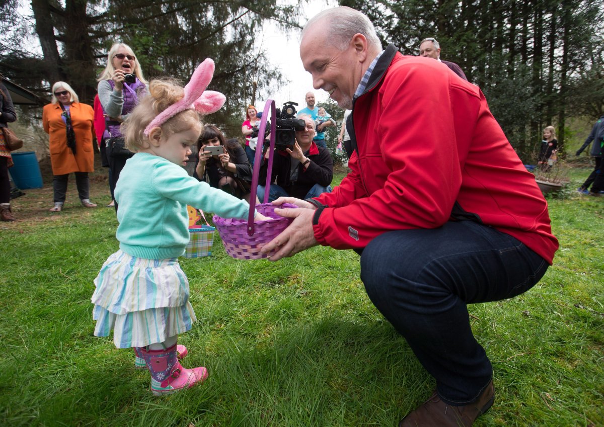 NDP Leader John Horgan hands out chocolates during an Easter egg hunt at a supporter's home in Maple Ridge, B.C., on Sunday April 16, 2017. A provincial election will be held on May 9. THE CANADIAN PRESS/Darryl Dyck.