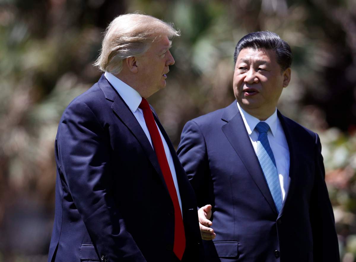 In this April 7, 2017 file photo, President Donald Trump, left, and Chinese President Xi Jinping walk together after their meetings at Mar-a-Lago, in Palm Beach, Fla.