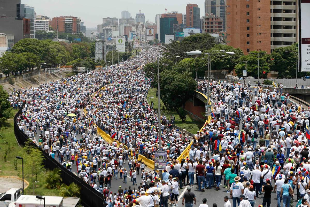 Anti-government protesters march along a highway in Caracas, Venezuela, Wednesday, April 19, 2017. Opponents of President Nicolas Maduro called on Venezuelans to take to the streets to march against the embattled socialist leader. (AP Photo/Ariana Cubillos)
