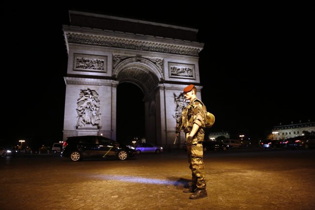 A soldier stands guard near the Arc of Thriomphe at the top of the Champs Elysees avenue in Paris, after a fatal shooting in which a police officer was killed along with an attacker, April 20, 2017. 

