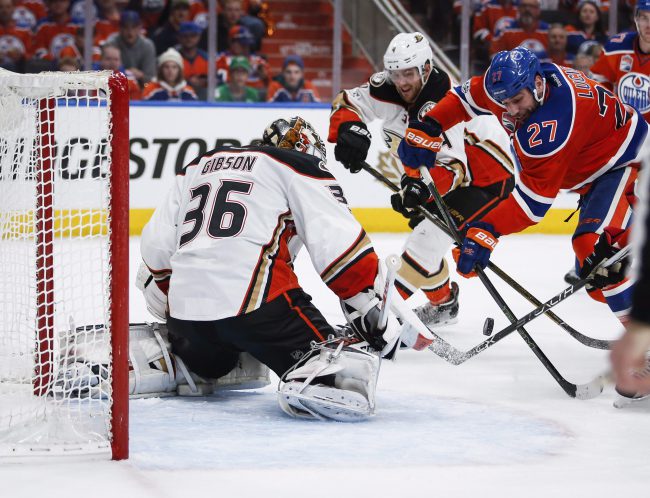 Anaheim Ducks goalie John Gibson, left, blocks the net on Edmonton Oilers' Milan Lucic, right, during second period NHL hockey round two playoff action in Edmonton, Sunday, April 30, 2017.