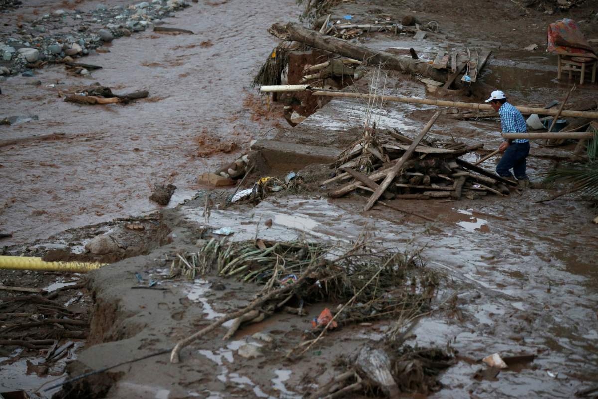 A man searches for his belongings after heavy rains caused several rivers to overflow, pushing sediment and rocks into buildings and roads in Mocoa, Colombia, April 1, 2017.