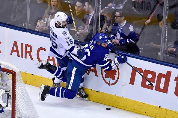 Toronto Maple Leafs Defenceman Roman Polak (46) and Tampa Bay Lightning Left Wing Michael Bournival (15) collide behind the net during the regular season NHL game between the Tampa Bay Lightning and Toronto Maple Leafs on April 6, 2017 at Air Canada Centre in Toronto, ON. (Photo by Gerry Angus/Icon Sportswire via Getty Images).