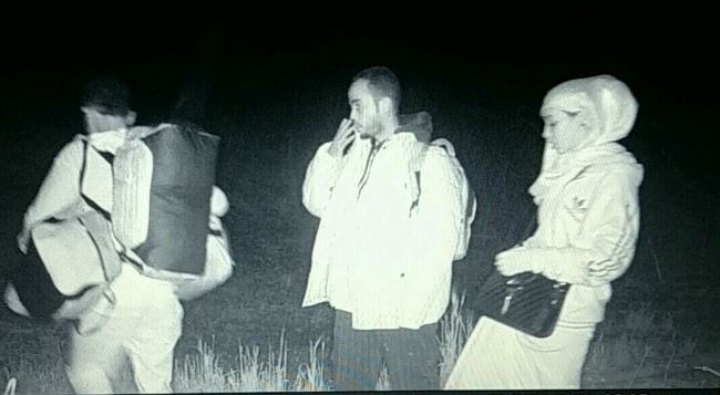 A wildlife camera captures asylum seekers crossing a field near Pembina, N.D. in November, 2016.