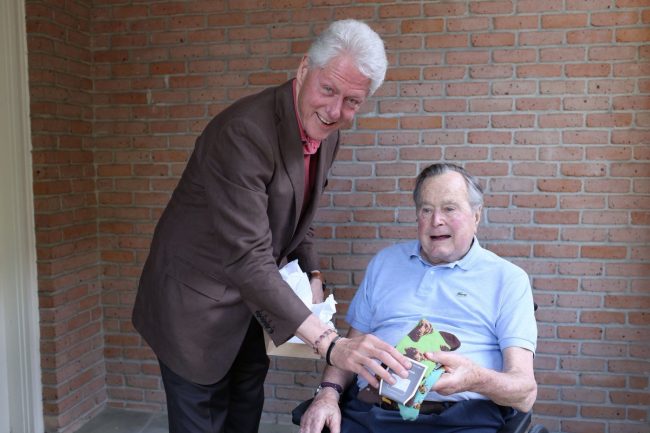 Former U.S. President Bill Clinton gifts socks to his predecessor, former President George H.W. Bush in Houston, Texas, Apr. 9, 2017.