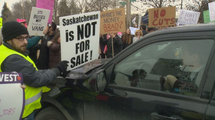 The provincial budget and new legislation drew criticism from people demonstrating outside the premier’s dinner at Prairieland Park.