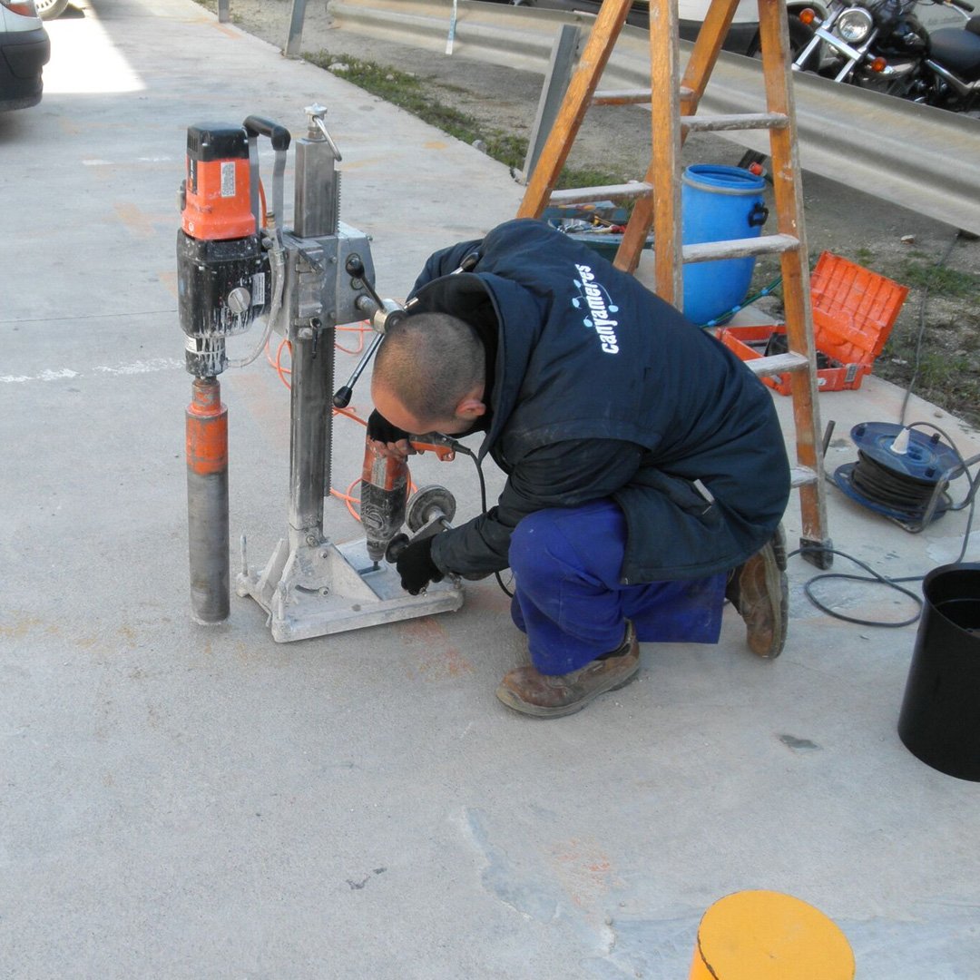 Crews installing parking occupancy sensors in downtown Burlington.