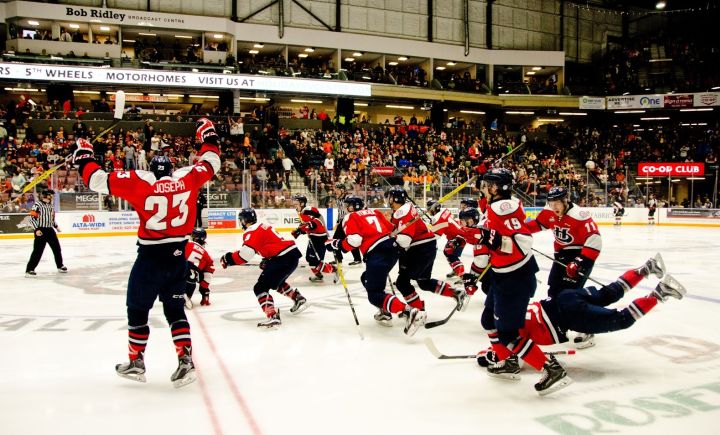 The Lethbridge Hurricanes charge the ice after a game seven overtime win over the Medicine Hat Tigers.