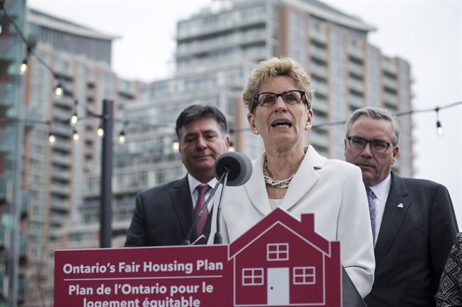Ontario Premier Kathleen Wynne, centre, is joined by Ontario Finance Minister Charles Sousa, left, and Ontario Housing Minister Chris Ballard in Toronto on Thursday, April 20, 2017 to speak about Ontario’s Fair Housing Plan.