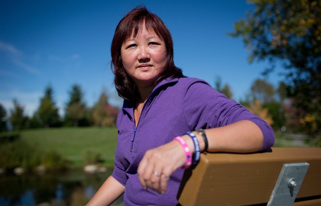 Carol Todd sits on a bench dedicated to her late daughter Amanda Todd at Settlers Park in Port Coquitlam, B.C., on Sunday October 5, 2013. The mother of a British Columbia teenager who took her own life after enduring cyberbullying says it's "just surreal" that the Dutch man charged in her daughter's case has been approved for extradition to Canada. 