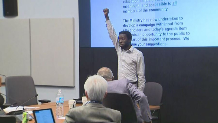 Desmond Cole appeared as a delegate at the Toronto Police Services Board Thursday afternoon. He said he was going to stand in protest until police were restricted from accessing data previously collected through carding.