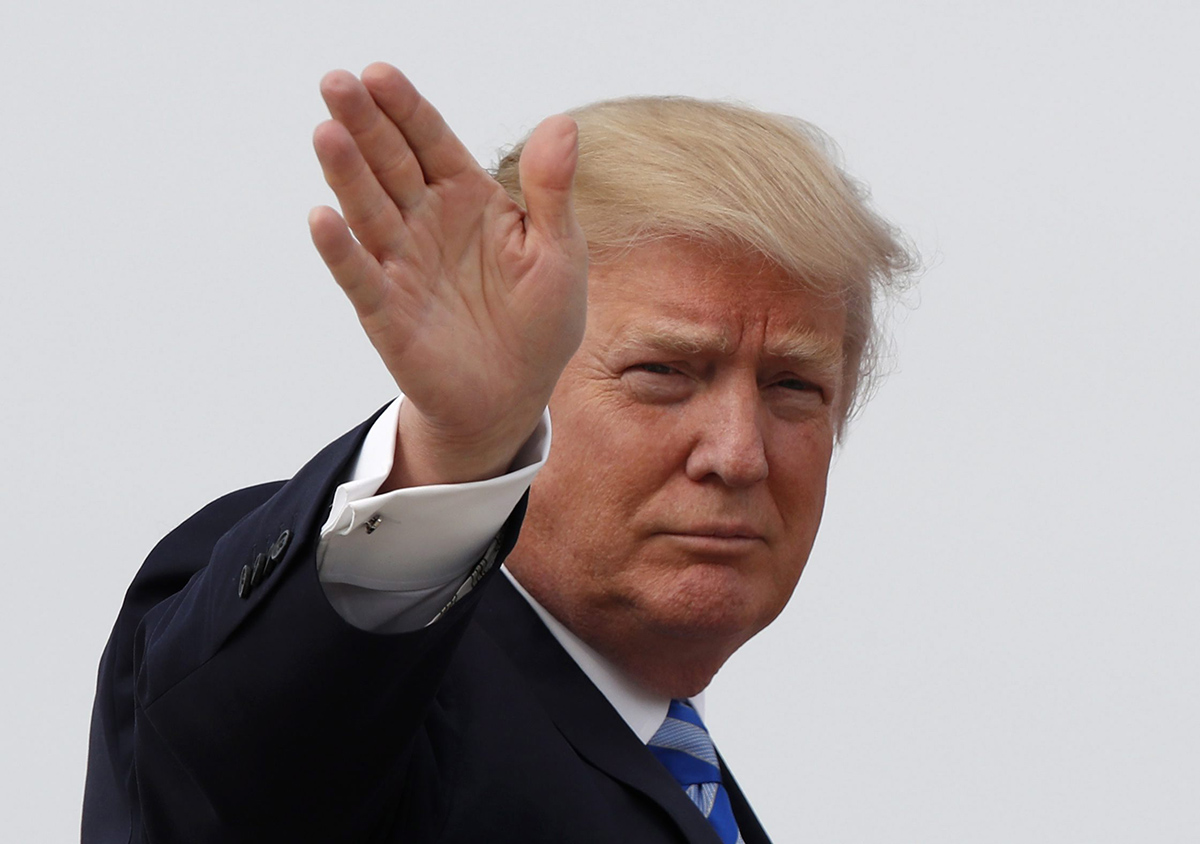 President Donald Trump waves as he boards Air Force One before his departure from Andrews Air Force Base, Md., Thursday, April 13, 2017, to his Mar-a-Largo resort in Florida.