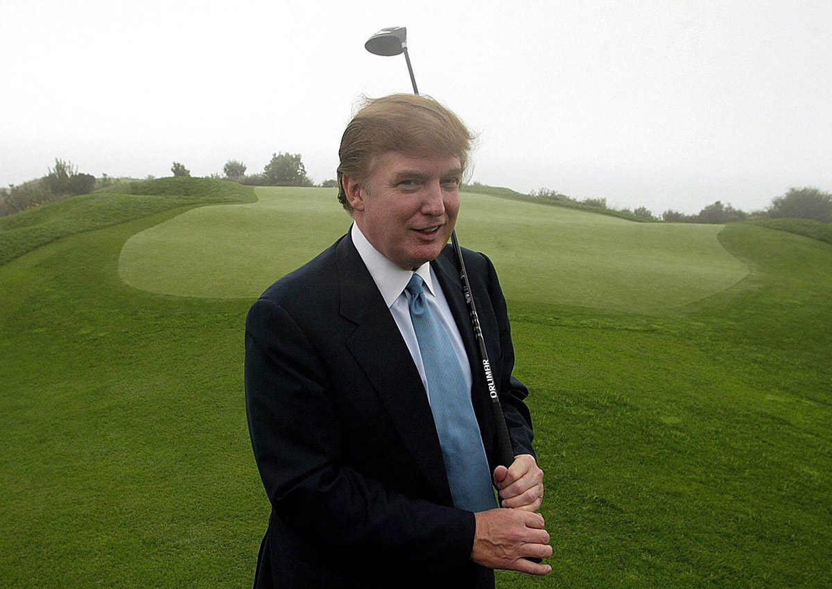 In this Saturday, Nov. 9, 2002 file photo, developer Donald Trump holds a driver up on the 11th green of his newly acquired Ocean Trails Golf Club in Rancho Palos Verdes, Calif.